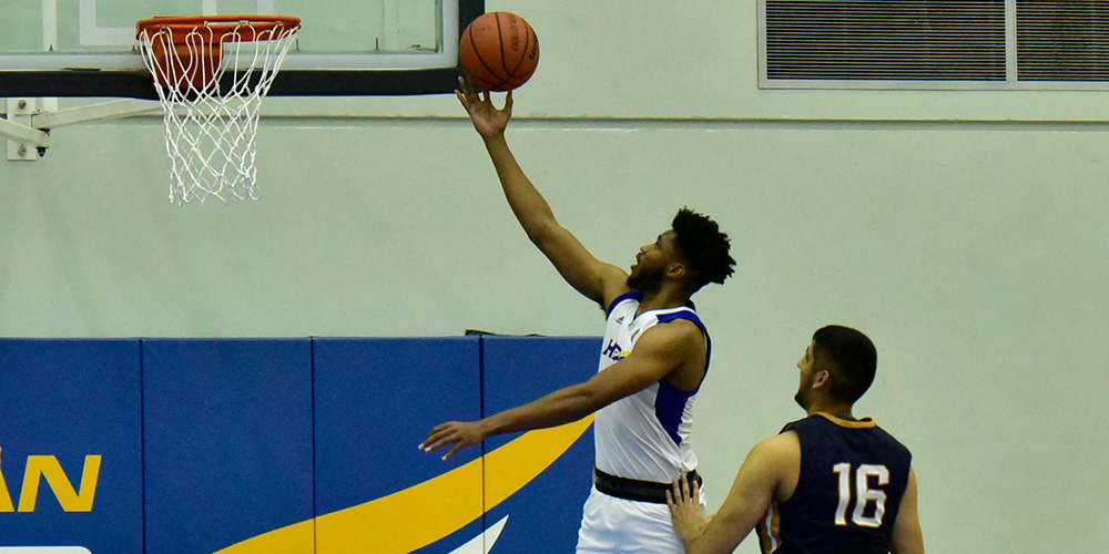 Player doing a lay up at a Men's UBCO Heat basketball game