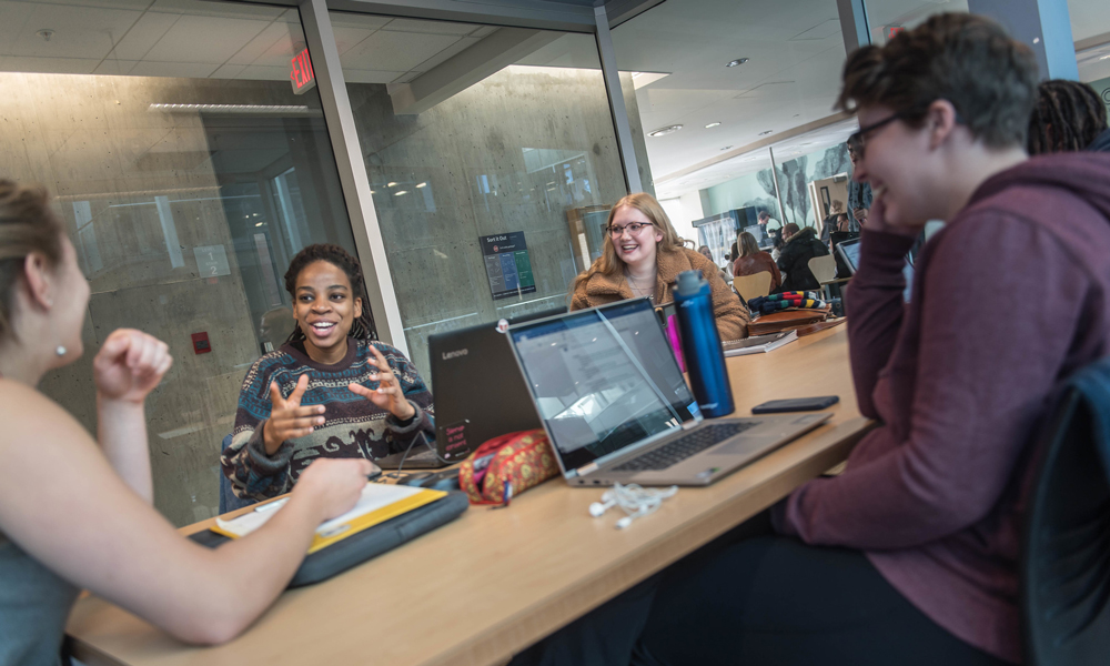 Individuals collaborating around a desk.