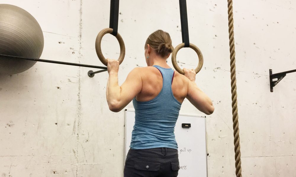 Individual using gymnastic rings.