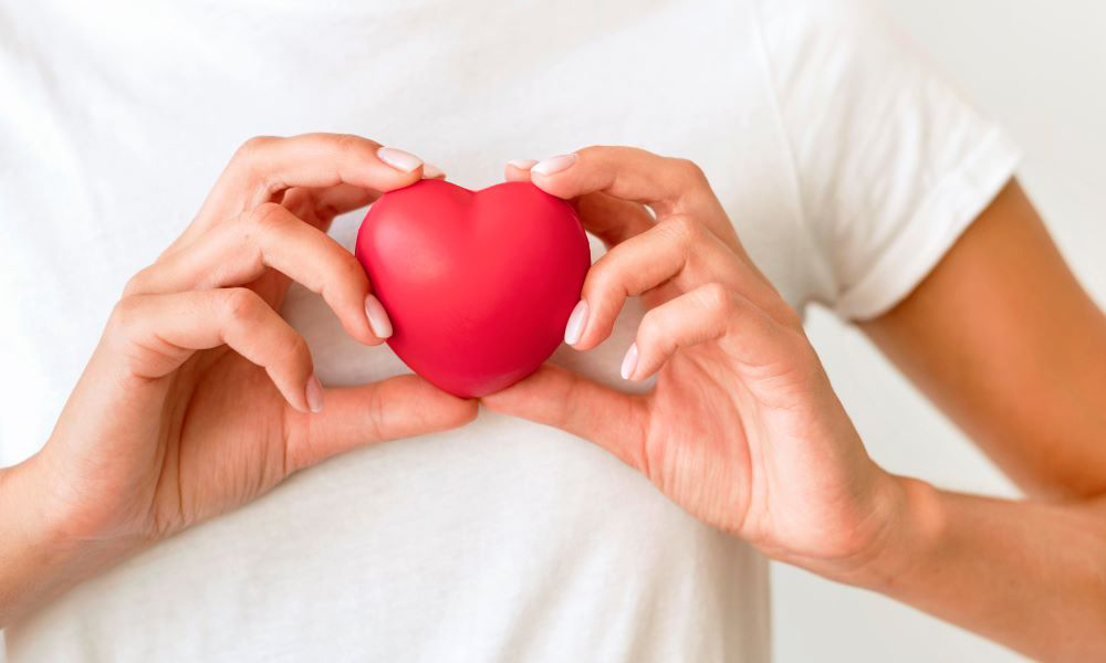 front view woman holding heart shape