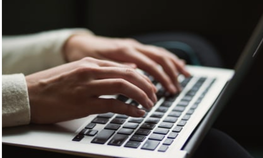 Person typing on keyboard.