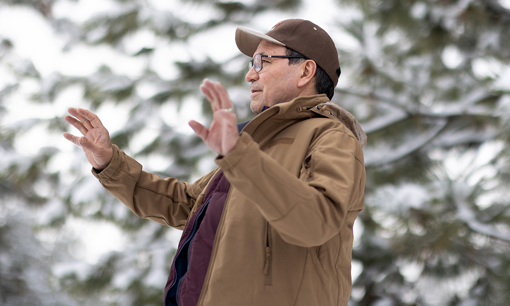 Dr. Bill Cohen standing in front of a snowy tree.